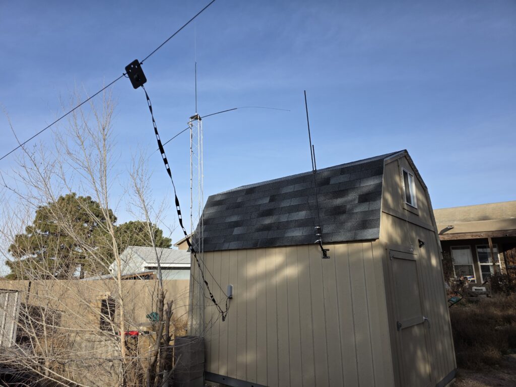 Hamshack, wire dipole, on tower two hamsticks in 40 meters acting as a dipole, and a 20 meter hamstick on the top.